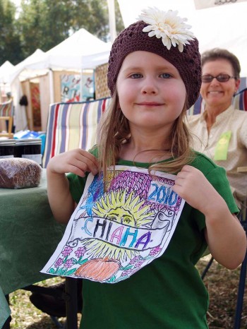 A girl with a coloring sheet at Chiaha Harvest Fair